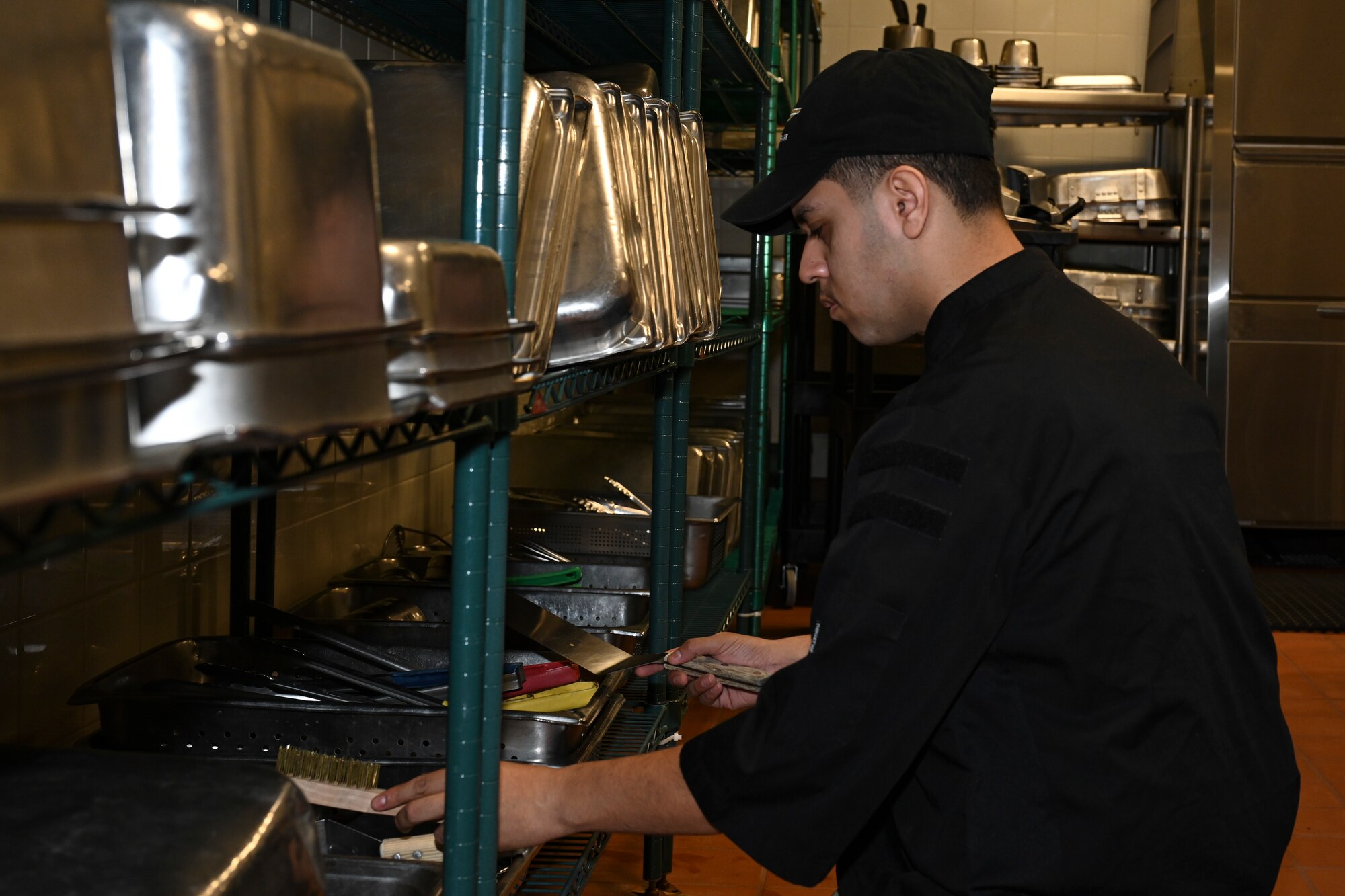 Airman 1st Class Miguel Ramirez, 8th Force Support Squadron food service apprentice, prepares to work the grill in the new dining facility at Kunsan Air Base.