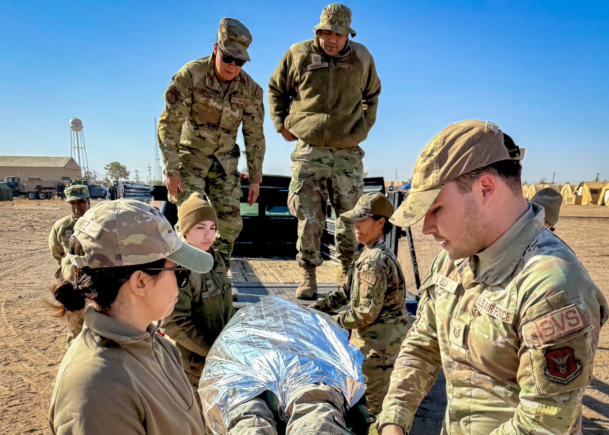 944th Fighter Wing Mortuary Affairs personnel load a simulated casualty onto a vehicle during Exercise Desert Hammer 25-1 at Gila Bend Air Force Auxiliary Field near Gila Bend, Ariz., Nov. 14, 2024. Set against the unmatched backdrop of the Barry M. Goldwater Range, Desert Hammer leverages Arizona’s strategic geography to provide realistic combat training for U.S. and allied forces. (U.S. Air Force photo by Maj. Casey Staheli)