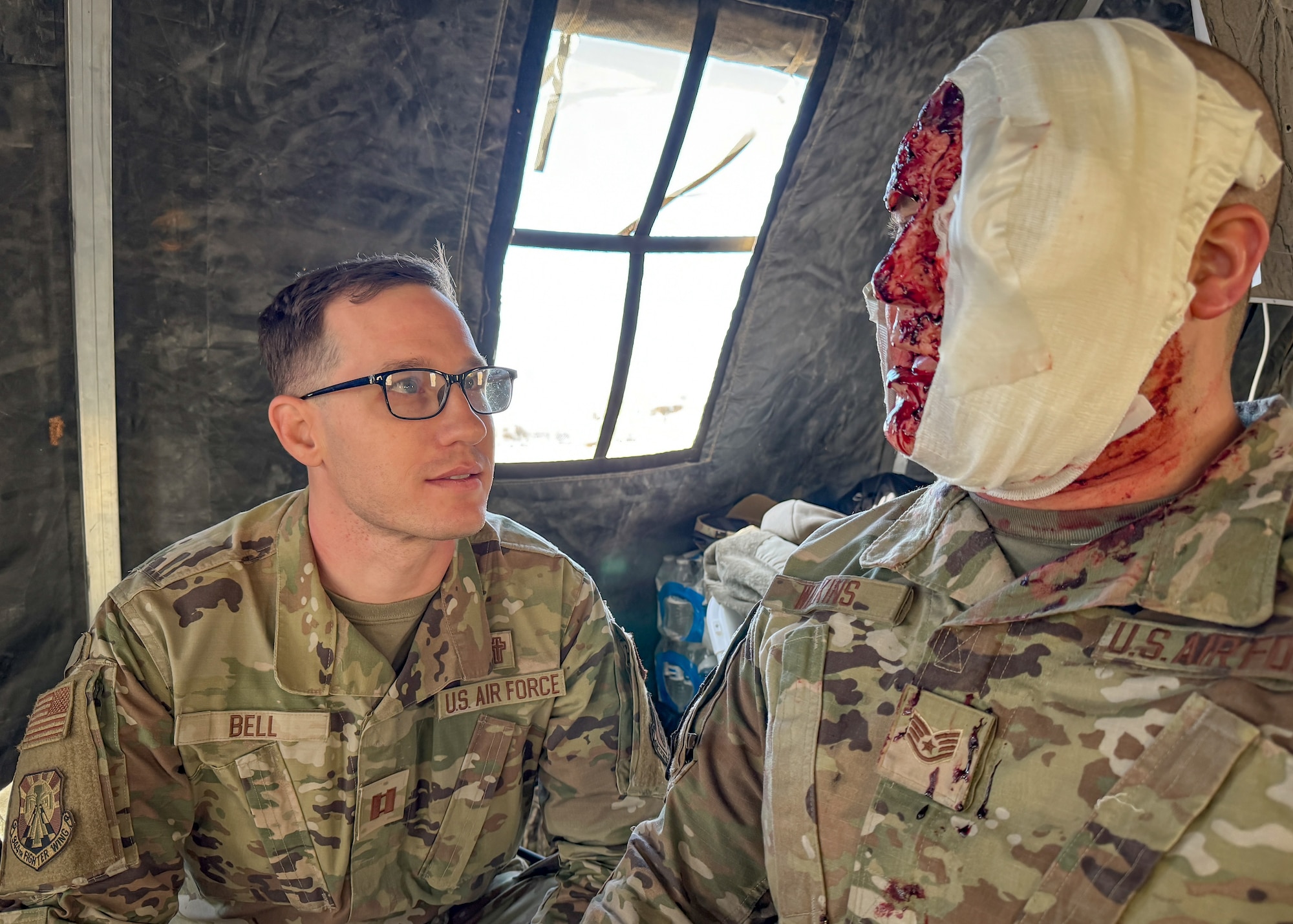 944th Fighter Wing Chaplain Capt. Matthew Bell engages with a simulated casualty during Exercise Desert Hammer 25-1 at Gila Bend Air Force Auxiliary Field near Gila Bend, Ariz., Nov. 14, 2024. Exercise Desert Hammer 25-1 emphasizes the U.S. Air Force Reserve’s commitment to readiness by integrating Agile Combat Support and Large Force Exercise capabilities in a contested environment. (U.S. Air Force photo by Maj. Casey Staheli)