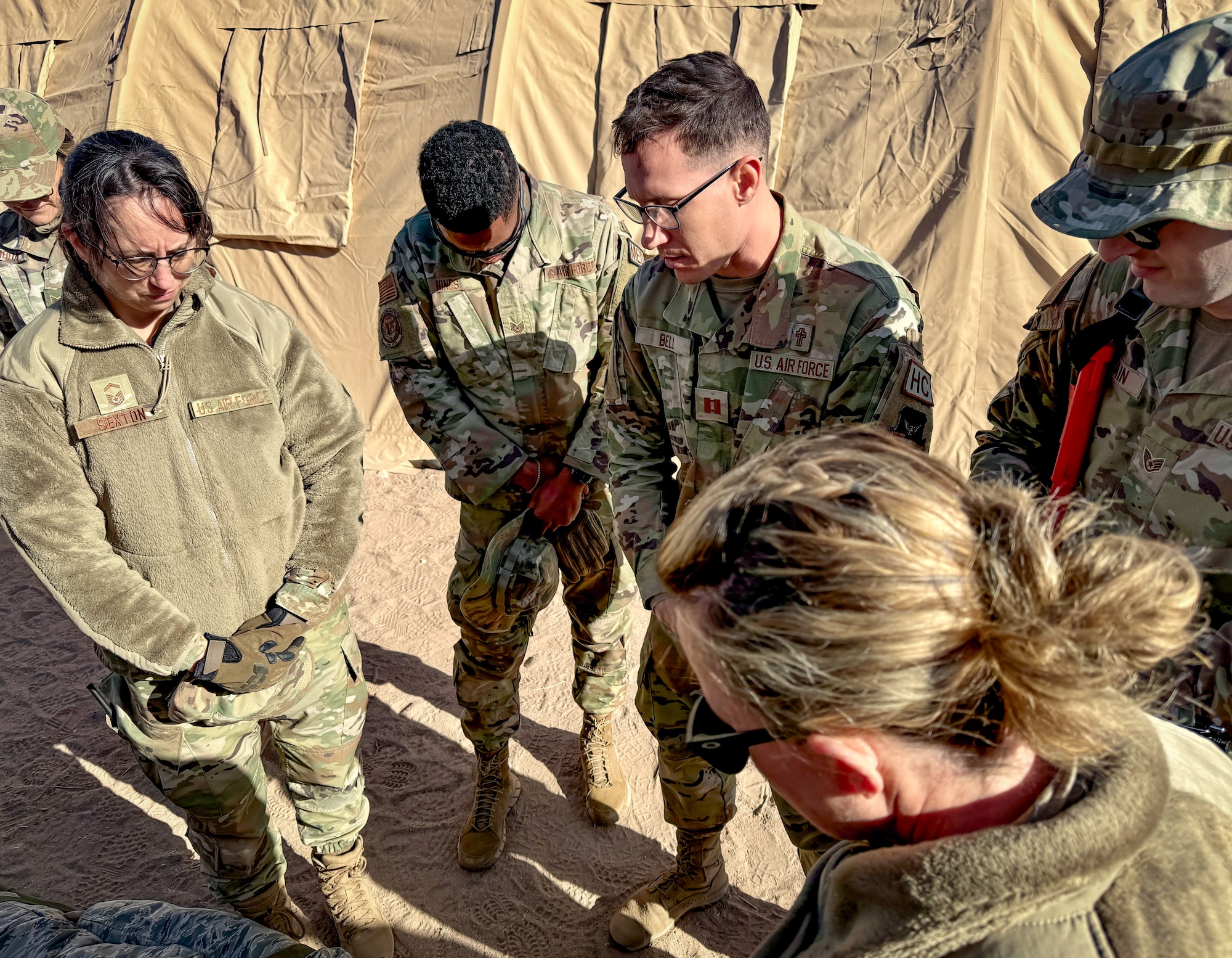 944th Fighter Wing Chaplain Capt. Matthew Bell leads a moment of reflection with Religious Affairs and Mortuary Affairs personnel during Exercise Desert Hammer 25-1 at Gila Bend Air Force Auxiliary Field near Gila Bend, Ariz., Nov. 14, 2024. This large-scale exercise showcases the adaptability of Mission Ready Airmen, advancing the skills needed to thrive in the rapidly evolving challenges of global competition. (U.S. Air Force photo by Maj. Casey Staheli)