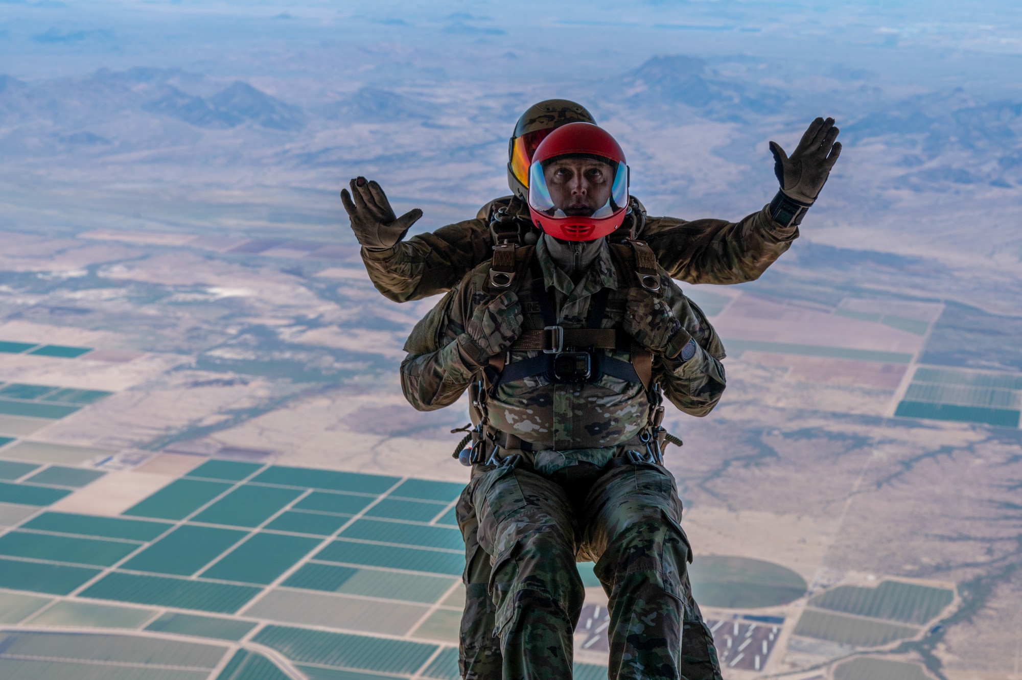 U.S. Air Force Reserve Citizen Airman Tech. Sgt. Daryl Thuline, 944th Security Forces Squadron assistant noncommissioned officer in charge, jumps in tandem with a pararescueman during Exercise Desert Hammer 25-1 exercise over Barry M. Goldwater Range East in southern Arizona, Nov. 14, 2024. Desert Hammer was a large-force joint exercise which included a number of scenarios such as specialized refueling operations and casualty evacuation. (U.S. Air Force photo by Senior Airman Devlin Bishop)
