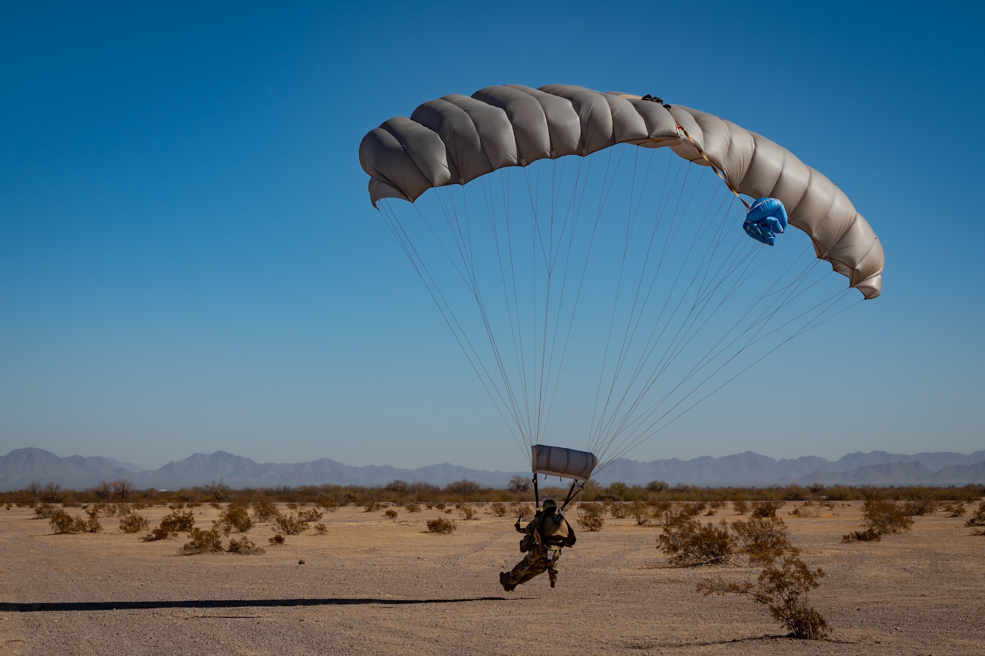 A U.S. Air Force Airman touches down at the landing zone during Exercise Desert Hammer 25-1 at Auxiliary Airfield 6 near Gila Bend, Ariz., Nov. 14, 2024. Exercise Desert Hammer 25-1 emphasizes the U.S. Air Force Reserve’s commitment to readiness by integrating Agile Combat Support and Large Force Exercise capabilities in a contested environment. (U.S. Air Force photo by Tech. Sgt. Tyler J. Bolken)