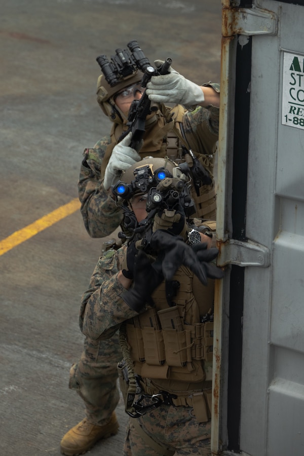 U.S. Marines with Force Reconnaissance Platoon, Maritime Raid Force, 31st Marine Expeditionary Unit, post security during a visit, board, search and seizure exercise at White Beach Naval Facility, Okinawa, Japan, Dec. 11, 2024. VBSS is part of maritime interception operations that aim to delay, disrupt, or destroy enemy forces or supplies in the maritime domain. The 31st MEU, the Marine Corps’ only continuously forward-deployed MEU, provides a flexible and lethal force ready to perform a wide range of military operations as the premiere crisis response force in the Indo-Pacific region. (U.S. Marine Corps photo by Pfc. Skilah Sanchez)