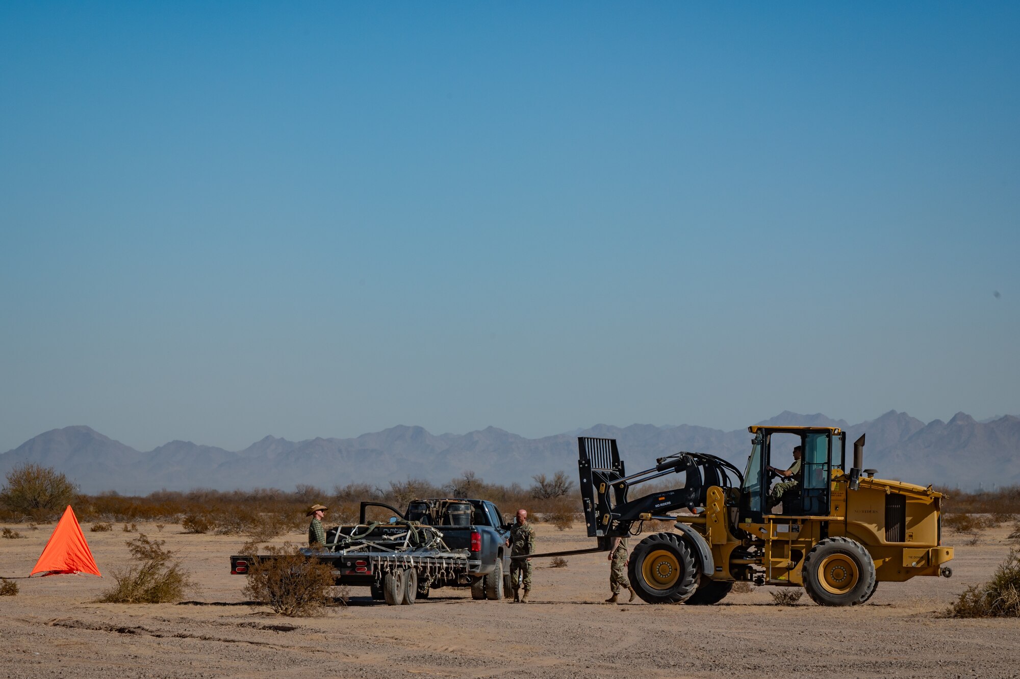 U.S. Air Force Airmen prepare to recover an airdropped cargo platform during Exercise Desert Hammer 25-1 at Auxiliary Airfield 6 near Gila Bend, Ariz., Nov. 14, 2024. Set against the unmatched backdrop of the Barry M. Goldwater Range, Desert Hammer leverages Arizona’s strategic geography to provide realistic combat training for U.S. and allied forces. (U.S. Air Force photo by Tech. Sgt. Tyler J. Bolken)