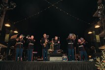 U.S. Marines assigned to Marine Band San Diego, Headquarters and Service Battalion, Marine Corps Recruit Depot San Diego, perform at the Little Italy tree lighting event San Diego, California, Dec. 7, 2024. The Marine Band San Diego’s job is to provide ceremonial music, boost morale and participate in outreach work and attend events and ceremonies. (U.S. Marine Corps photo illustration by Lance Cpl. Janell B. Alvarez)