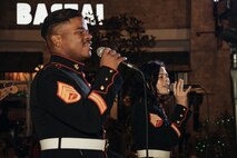 U.S. Marine Corps Staff Sgt. Adam Chandler, front, vocalist and Sgt. Kaise Wagner, vocalist both with Marine Band San Diego, Headquarters and Service Battalion, Marine Corps Recruit Depot San Diego, perform at the Little Italy tree lighting event, San Diego, California, Dec. 7, 2024. The Marine Band San Diego’s job is to provide ceremonial music, boost morale and participate in outreach work and attend events and ceremonies. (U.S. Marine Corps photo by Lance Cpl. Janell B. Alvarez)
