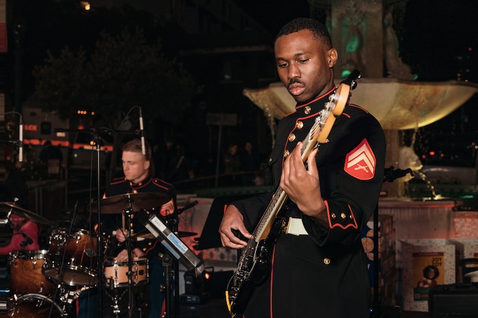 U.S. Marine Corps Cpl. Desean Porchea, bassist with Marine Band San Diego, Headquarters and Service Battalion, Marine Corps Recruit Depot San Diego, performs at the Little Italy tree lighting event, San Diego, California, Dec. 7, 2024. The Marine Band San Diego’s job is to provide ceremonial music, boost morale and participate in outreach work and attend events and ceremonies. (U.S. Marine Corps photo by Lance Cpl. Janell B. Alvarez)