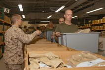 U.S. Marine Corps recruits with Lima Company, 3rd Recruit Training Battalion, are issued uniforms during their uniform fitting at Marine Corps Recruit Depot San Diego, California, Nov. 27, 2024. Recruits are fitted twice during training, on Training Day 27 in Phase 2 and the sixth day of Marine Week in Phase 4, to ensure their uniforms are ready to be worn properly as Marines. (U.S. Marine Corps photo by Lance Cpl. Janell B. Alvarez)