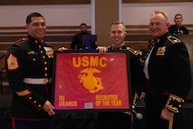 U.S. Marine Corps Gunnery Sgt. Eduardo Villalobos, a canvassing recruiter with Recruiting Sub-Station Norwalk, Recruiting Station Orange County, receives the Recruiter of the Year plaque during a Marine Corps Birthday Ball Ceremony in Irvine, California, Nov. 26, 2024. Recruiting Station Orange County consists of twenty RSS's, Primary Contact Stations and Officer Selection Stations ranging from Los Angeles to Orange County. (U.S. Marine Corps photo by Cpl. Fred Garcia)