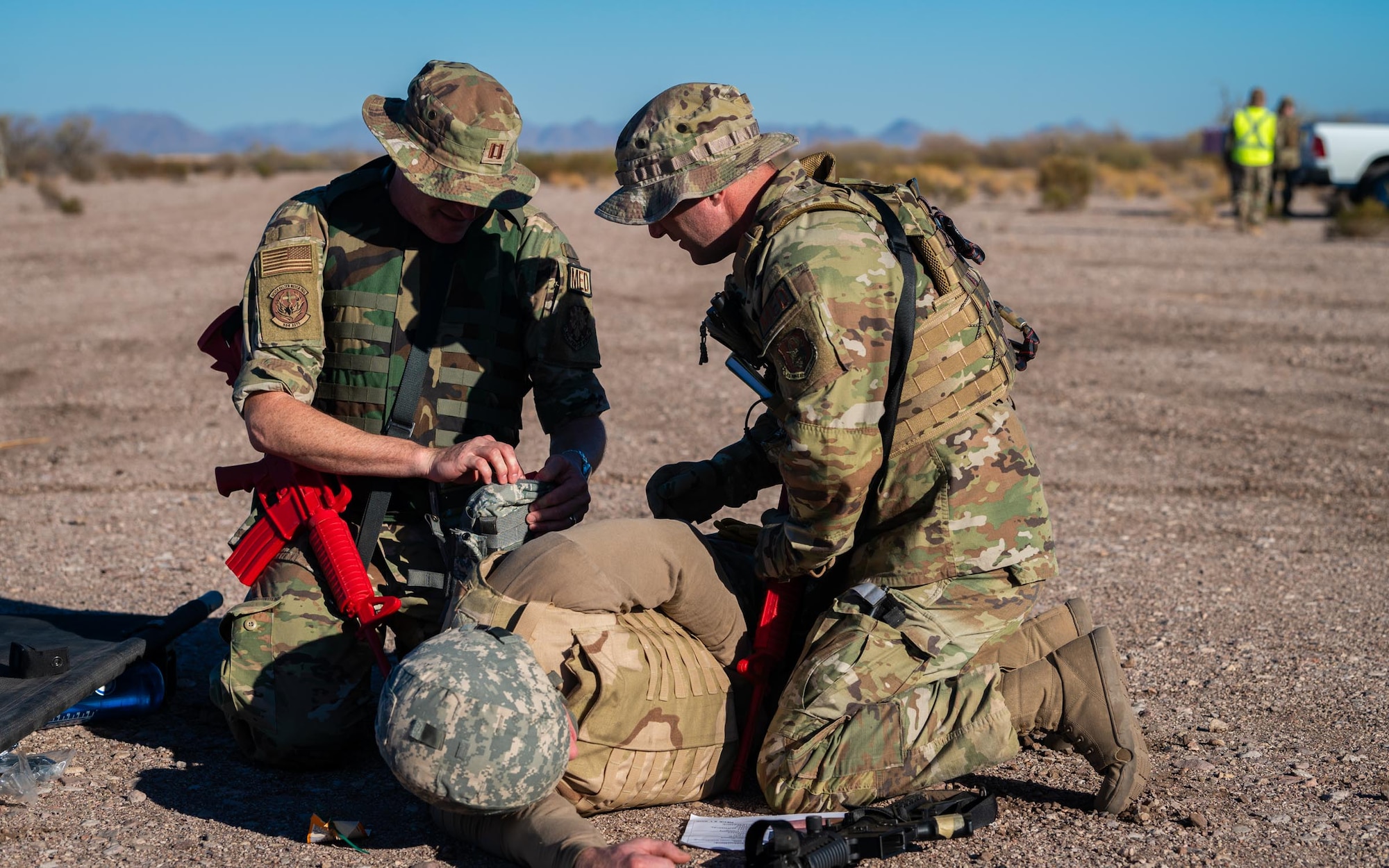 A 944th Fighter Wing U.S. Air Force Reserve Citizen Airmen provide simulated medical care to a casualty during Exercise Desert Hammer 25-1 at Auxiliary Airfield 6 near Gila Bend, Ariz., Nov. 14, 2024. Through joint and multinational collaboration, Desert Hammer tests the ability of over 700 participants and 131 aircraft to operate, defend, and sustain airbases under austere conditions. (U.S. Air Force photo by Senior Airman Jacob Dastas)