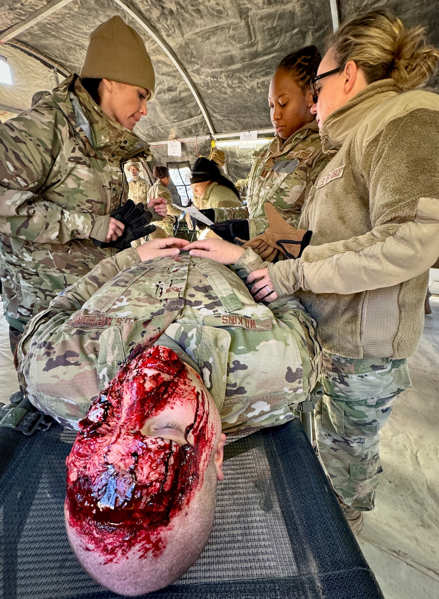 944th Fighter Wing Reserve Citizen Airmen provide care for simulated injuries in a combat training scenario during Exercise Desert Hammer 25-1 at Gila Bend Air Force Auxiliary Field, Ariz., Nov. 14, 2024. This large-scale exercise showcases the adaptability of Mission Ready Airmen, advancing the skills needed to thrive in the rapidly evolving challenges of global competition. (U.S. Air Force photo by Maj. Casey Staheli)