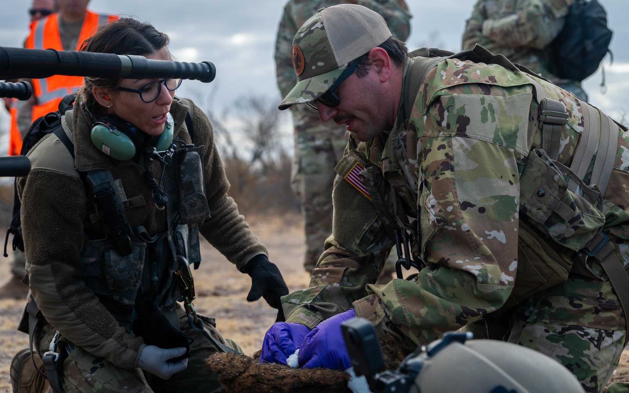 944th Fighter Wing U.S. Air Force Reserve Citizen Airmen and Arizona Army National Guard Soldiers simulate treating a fake critically injured working dog during Exercise Desert Hammer 25-1 at Auxiliary Field 6 near Gila Bend, Ariz., Nov. 16, 2024. This large-scale exercise showcases the adaptability of Mission Ready Airmen, advancing the skills needed to thrive in the rapidly evolving challenges of global competition. (U.S. Air Force photo by Senior Airman Jacob Dastas)