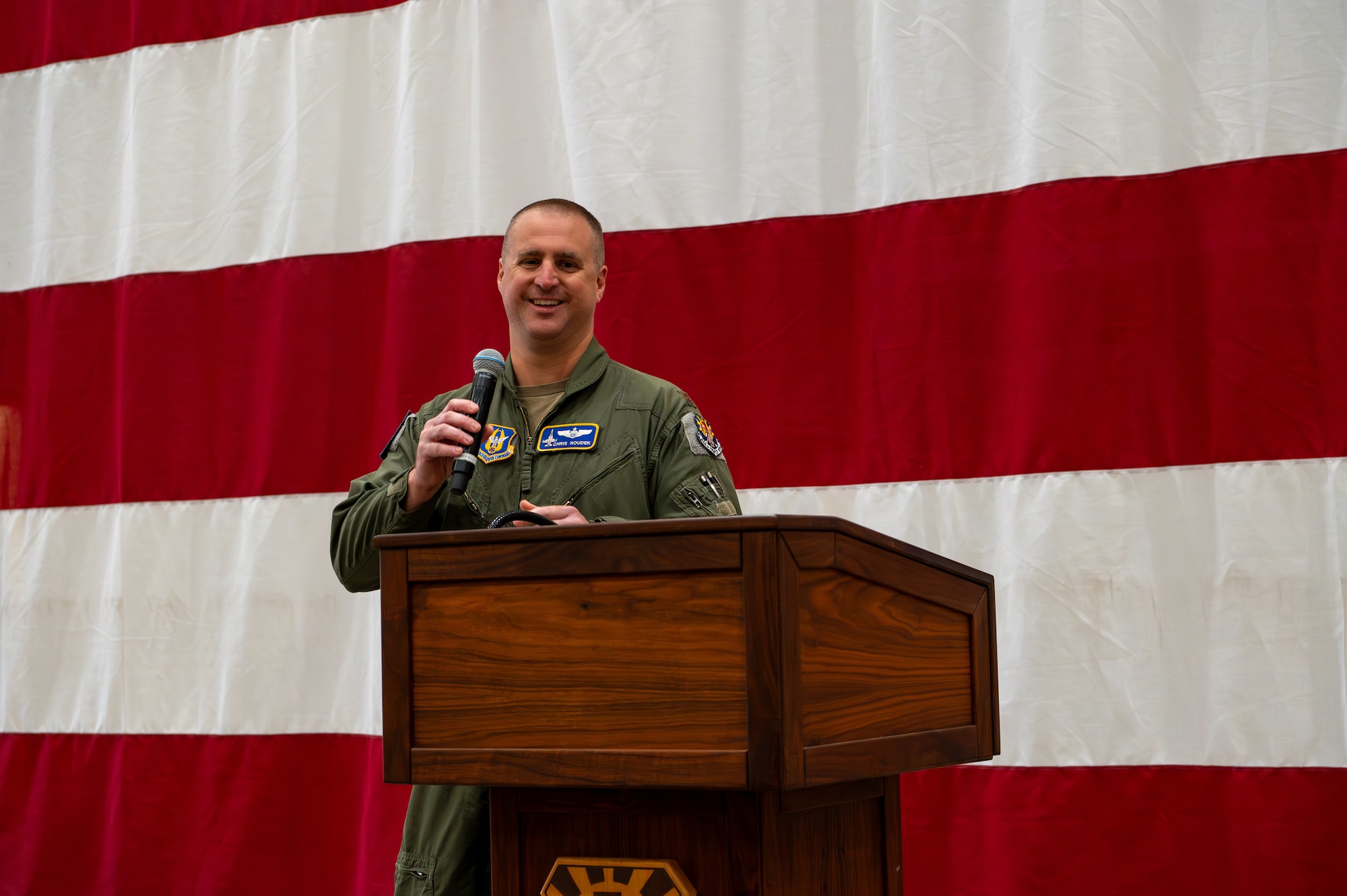 U.S. Air Force Maj. Chris Houdek, 944th Fighter Wing chief of exercises and plans addresses the Airmen of the 944th Fighter Wing during a homecoming celebration at Luke Air Force Base, Ariz., Nov. 17, 2024, following the conclusion of Exercise Desert Hammer 25-1. Through joint and multinational collaboration, Desert Hammer tests the ability of over 700 participants and 131 aircraft to operate, defend, and sustain airbases under austere conditions. (U.S. Air Force photo by Senior Airman Alexis Orozco)