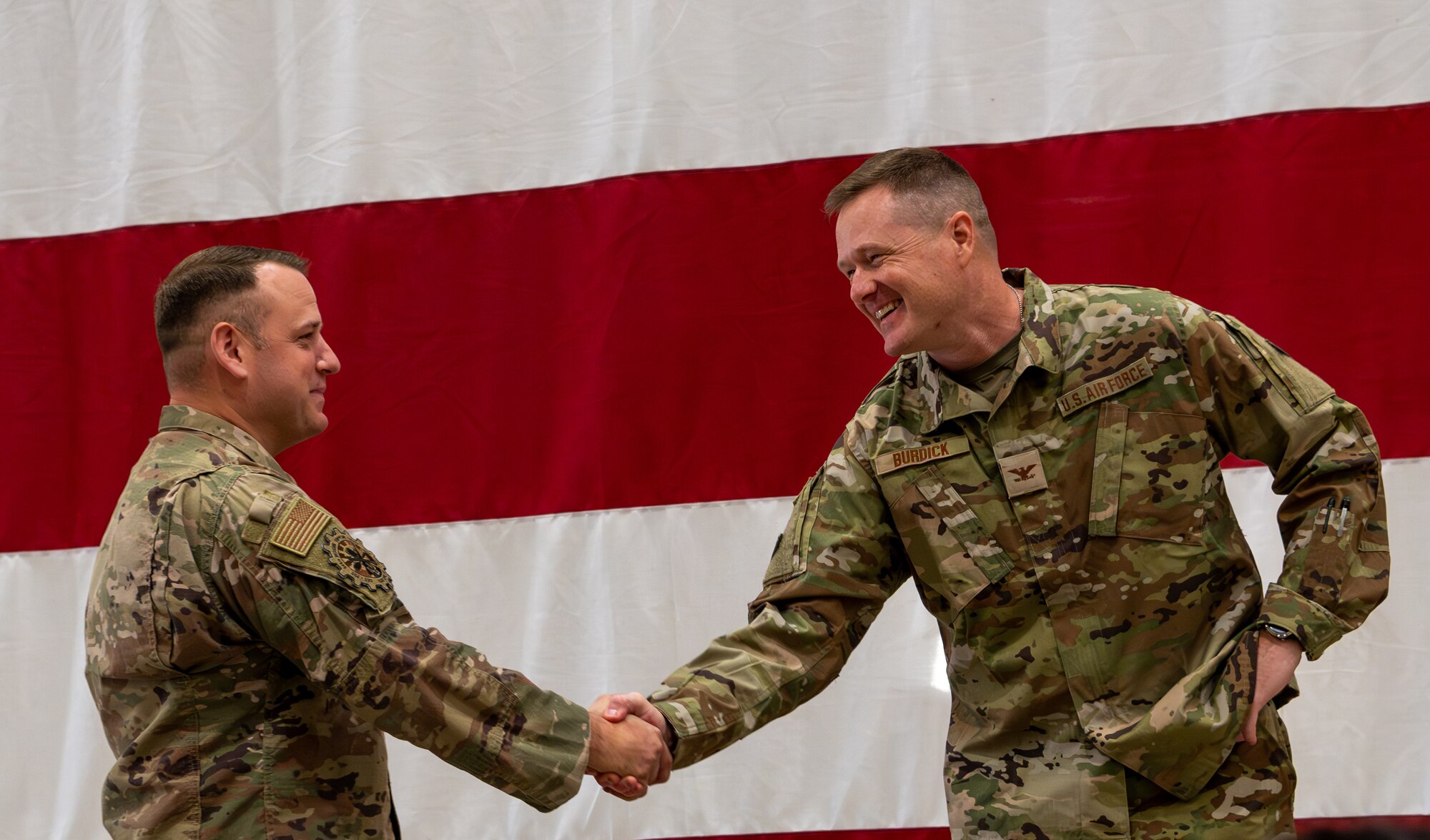 (Left to Right) Chief Master Sgt. Gregory Locke, 944th Mission Support Group Senior Enlisted Leader, and Col. Chad Burdick, 944th Fighter Wing Deputy Commander, shake hands during a homecoming celebration at Luke Air Force Base, Ariz., Nov. 17, 2024, following the conclusion of Exercise Desert Hammer 25-1. Set against the unmatched backdrop of the Barry M. Goldwater Range, Desert Hammer leverages Arizona’s strategic geography to provide realistic combat training for U.S. and allied forces. (U.S. Air Force photo by Senior Airman Alexis Orozco)