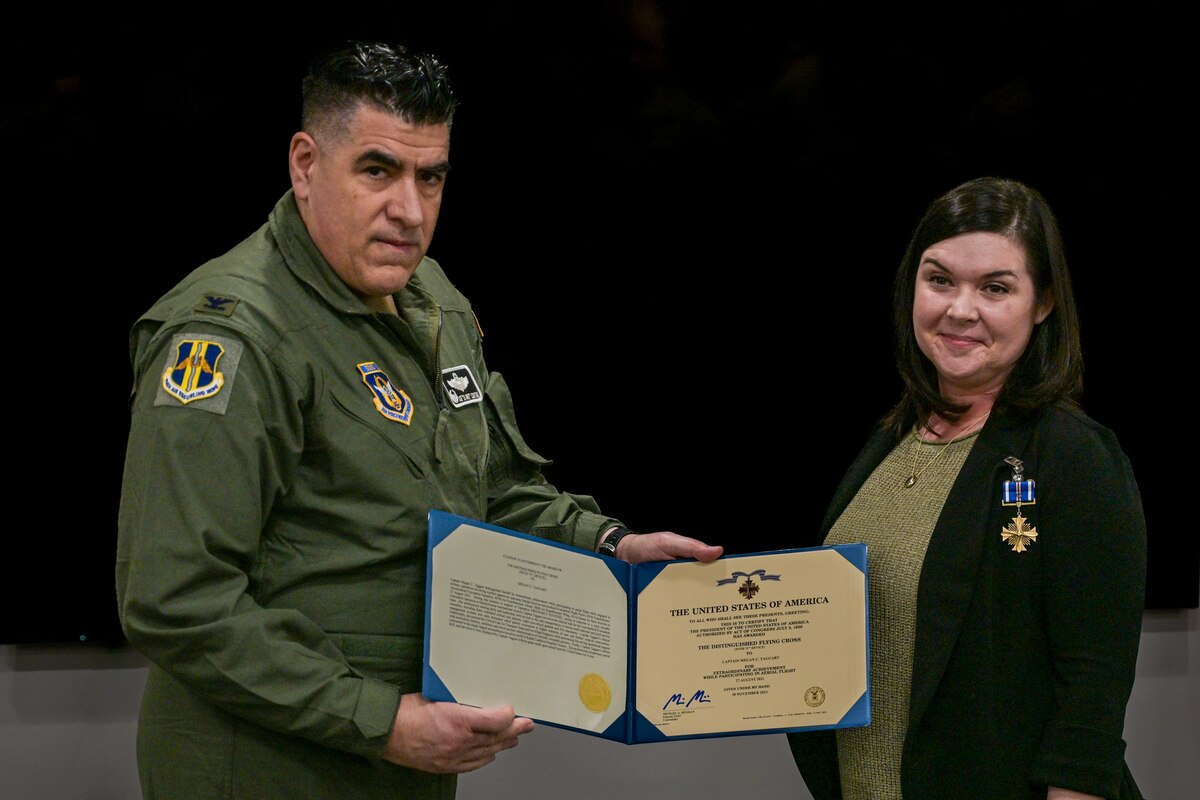 Col. Joseph “20 Grit” Contino, 914th Air Refueling Wing commander, left, awards U.S. Air Force Capt. Megan Taggart, 914th Aeromedical Evacuation Squadron Flight Nurse, the Distinguished Flying Cross Award at the Niagara Falls Air Reserve Station, New York on Dec.8, 2024.