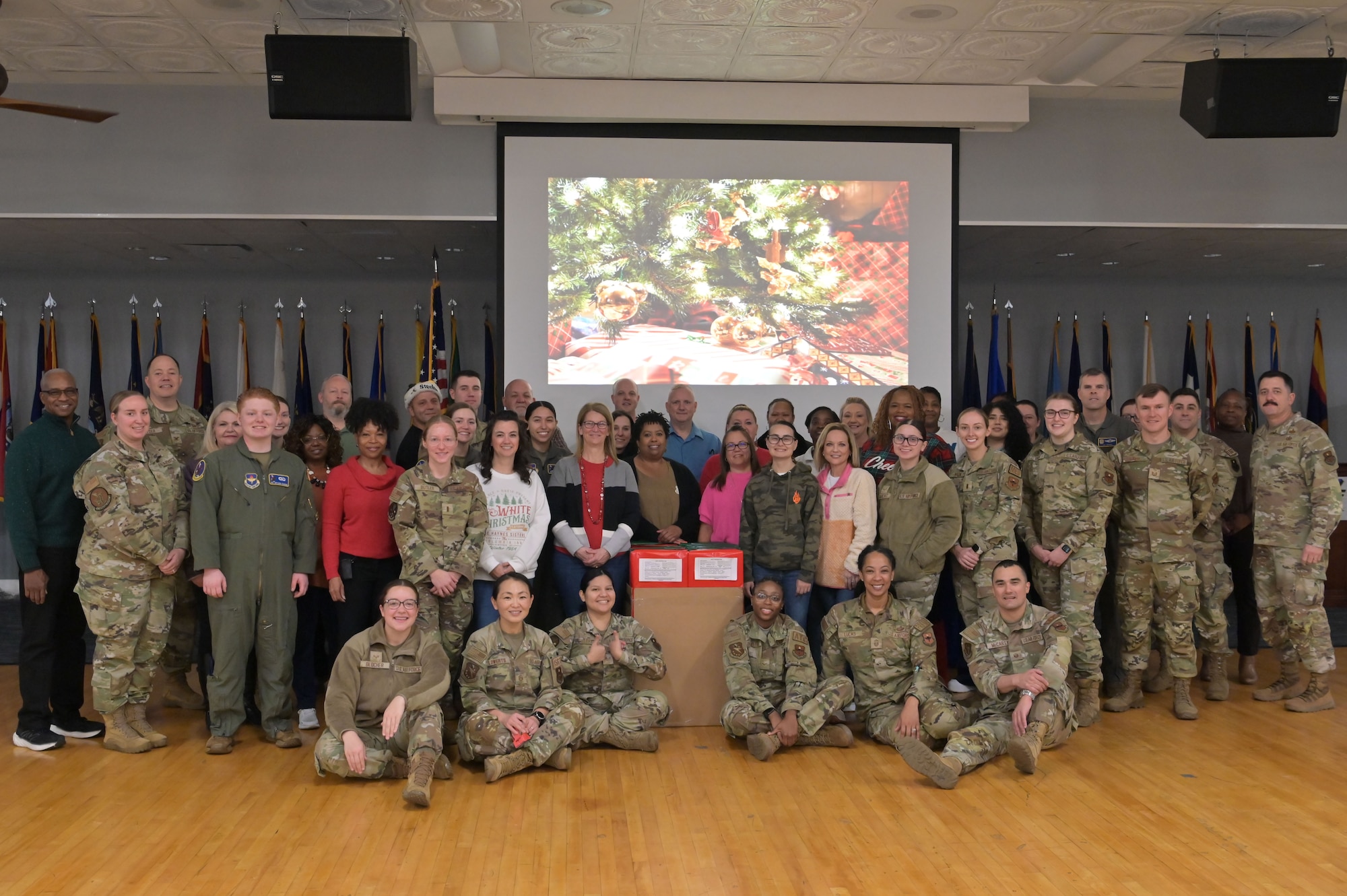 Airmen and civilian volunteers pose for a photo at the Columbus Air Force Base Event Center on Columbus Air Force Base, Dec. 11, 2024.