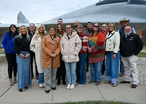 17th Training Wing Honorary Commanders pose for a photo at a MiG-29 trainer, Goodfellow Air Force Base, Texas, Dec. 6, 2024. The honorary commanders attended the first of five immersions to experience the mission of the 17th TRW. (U.S. Air Force photo by Airman 1st Class Evelyn J. D’Errico)