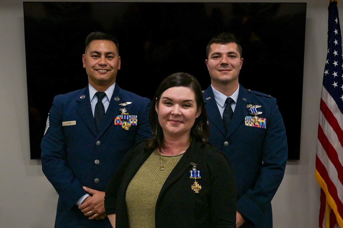Pictured left to right:  U.S. Air Force Master Sgt. Jerry Thorn, Aeromedical Evacuation Technician, U.S. Air Force Capt. Megan Taggart, Flight Nurse, and U.S. Air Force Lt. Joseph Hansen, Flight Nurse, all from the 914th Aeromedical Evacuation Squadron, receive the Distinguished Flying Cross Award at the Niagara Falls Air Reserve Station, New York, Dec. 8, 2024.