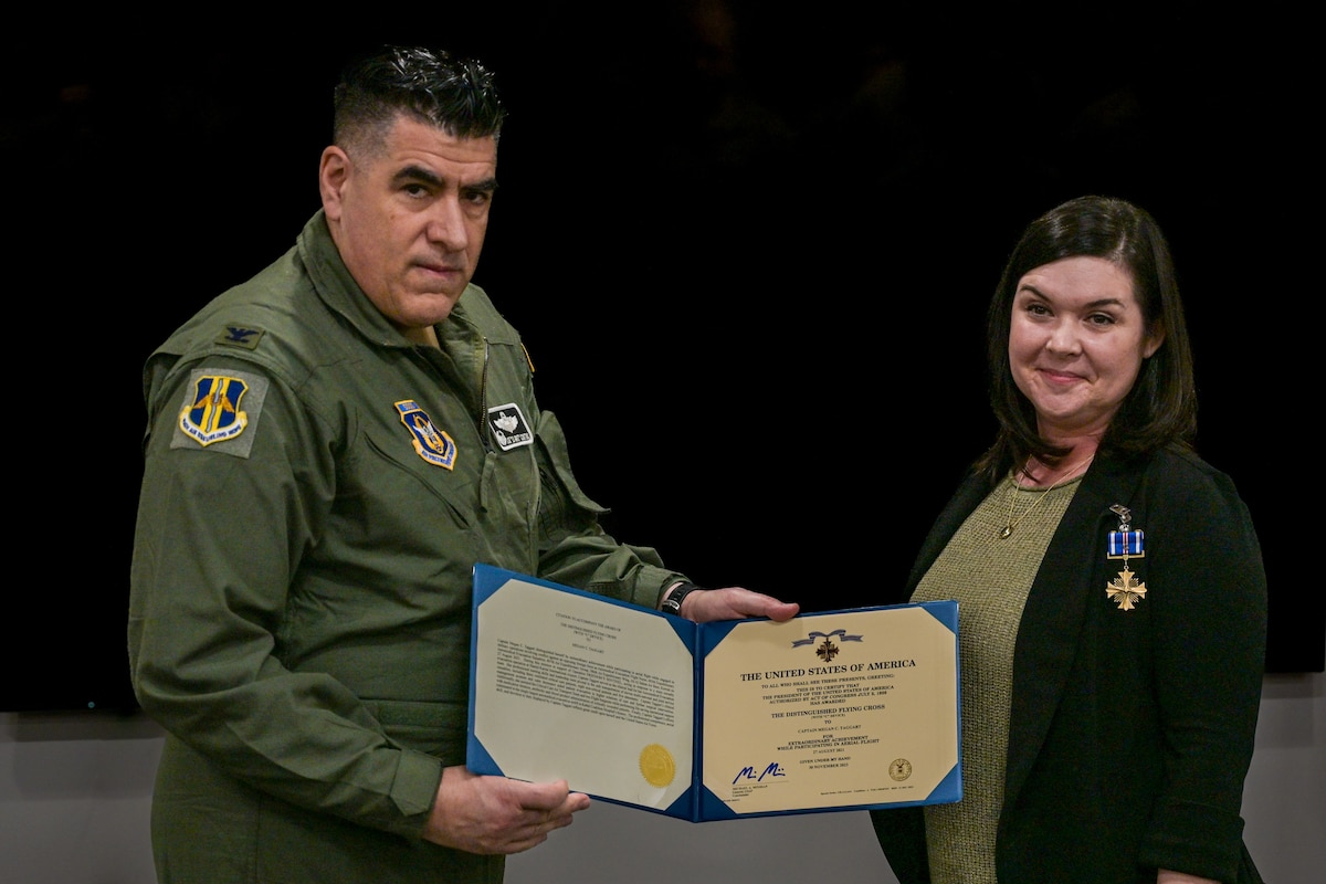 Col. Joseph “20 Grit” Contino, 914th Air Refueling Wing commander, left, awards U.S. Air Force Capt. Megan Taggart, 914th Aeromedical Evacuation Squadron Flight Nurse, the Distinguished Flying Cross Award at the Niagara Falls Air Reserve Station, New York on Dec.8, 2024.