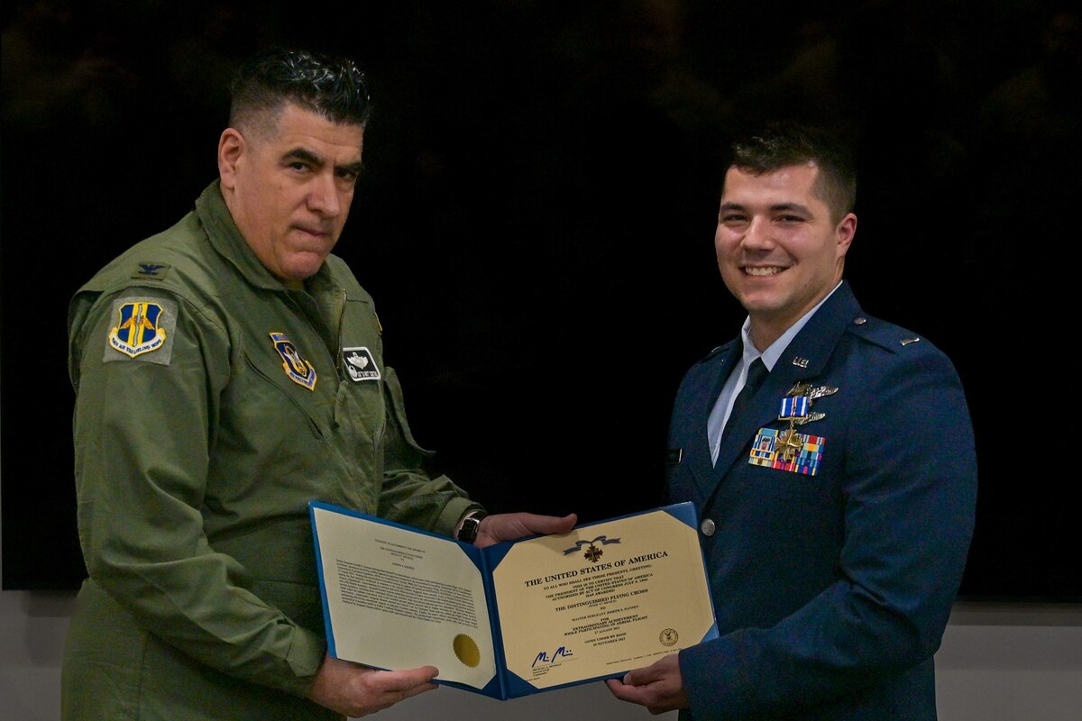 Col. Joseph “20 Grit” Contino, 914th Air Refueling Wing commander, left, presents U.S. Air Force Lt. Joseph Hansen, 914th Aeromedical Evacuation Squadron Flight Nurse, the Distinguished Flying Cross Award at the Niagara Falls Air Reserve Station, New York, Dec. 8, 2024.