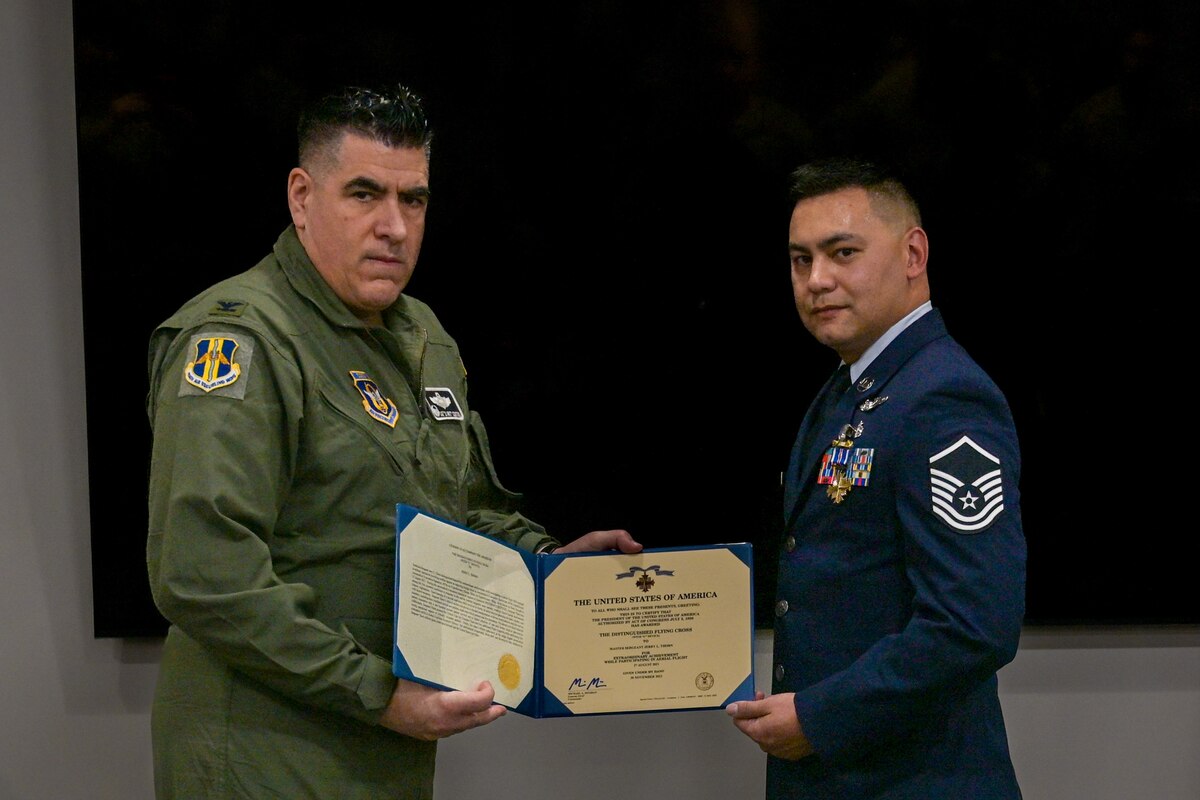 Col. Joseph “20 Grit” Contino, left, 914th Air Refueling Wing commander, awards U.S. Air Force Master Sgt. Jerry Thorn, 914th Aeromedical Evacuation Squadron AE Technician, the Distinguished Flying Cross Award.