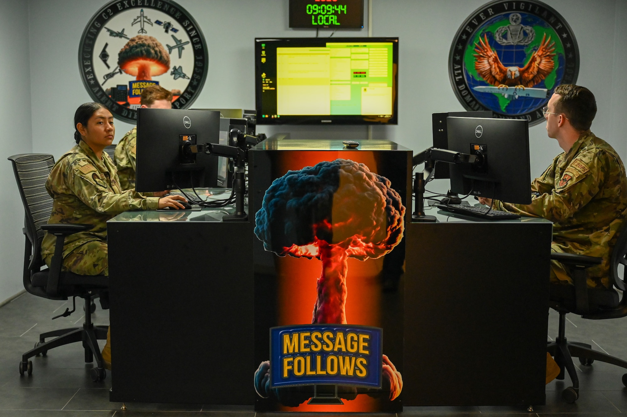U.S. Air Force Staff Sgt. Grant Welsh, 334th Training Squadron instructor, right, leads students through an emergency notification training scenario in the new command post study room on Keesler Air Force Base, Mississippi, Oct. 30, 2024.