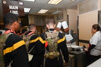 Senior leaders from the 433rd Alamo Wing serve meals to service members during the “Feed the Troops” event at the Live Oak Dining Facility on Joint Base San Antonio-Lackland, Texas, Dec. 7, 2024.