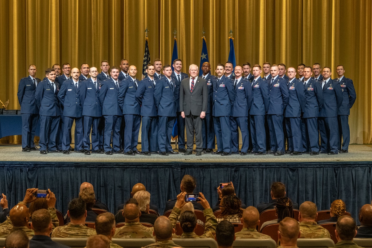 Secretary of the Air Force Frank Kendall with the group of the new Air Force Warrant Officer Training School students after their graduation ceremony at Maxwell Air Force Base, Alabama, Dec. 6, 2024.