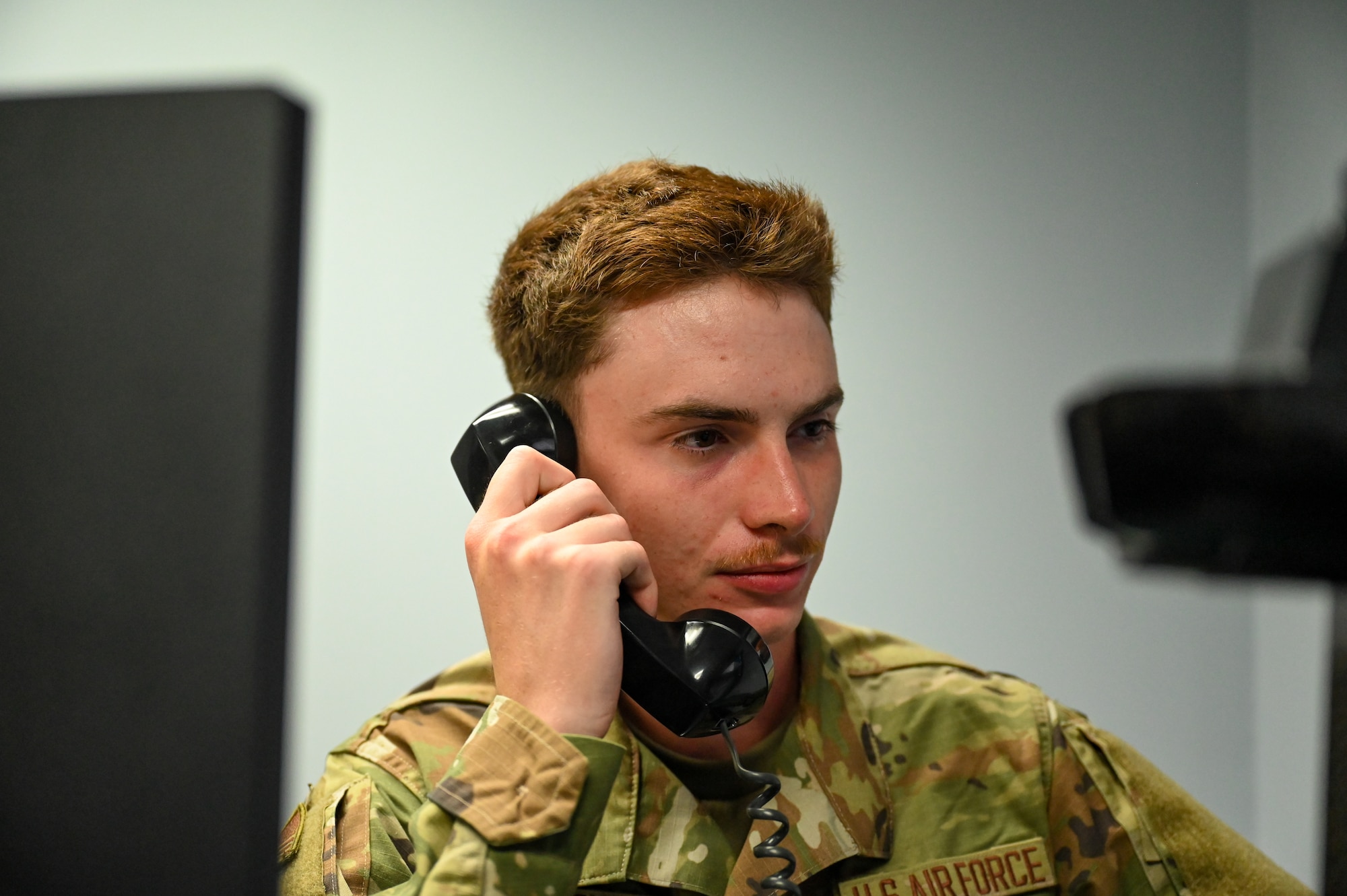 U.S. Airman Tyler Riley, 334th Training Squadron student, simulates an emergency notification in the new command post study room on Keesler Air Force Base, Mississippi, Oct. 30, 2024.