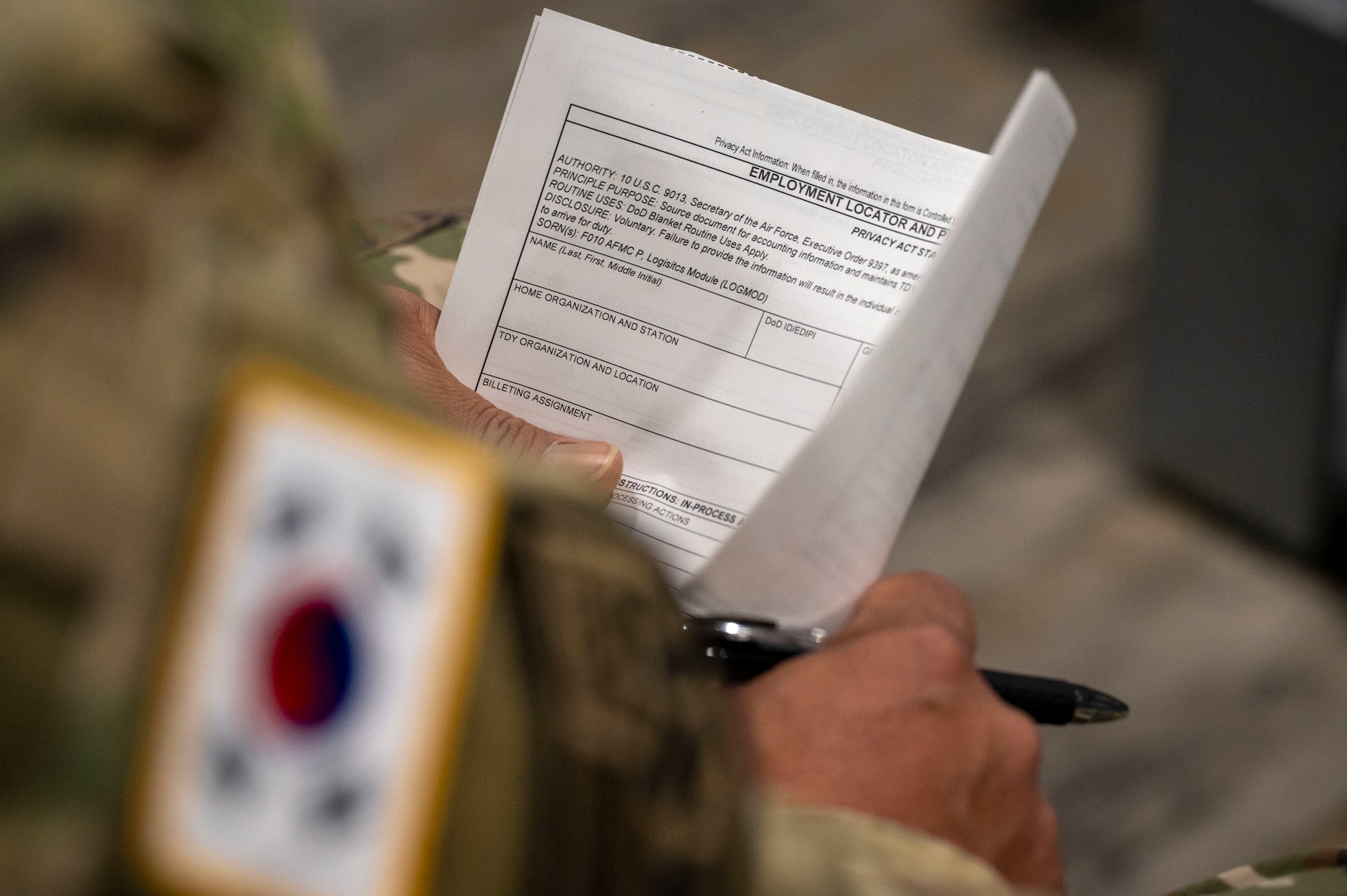A Korean Service Corps Pyeongtaek Mobilization Station member fills out an employment locator form during a simulated contingency operations training at Osan Air Base, Republic of Korea, Dec. 5, 2024. The KSC executes logistics operations from downloading aircraft and supplies to operating vehicles, their cooperation bolsters cargo deployment functions. (U.S. Air Force photo by Senior Airman Sabrina Fuller-Judd)