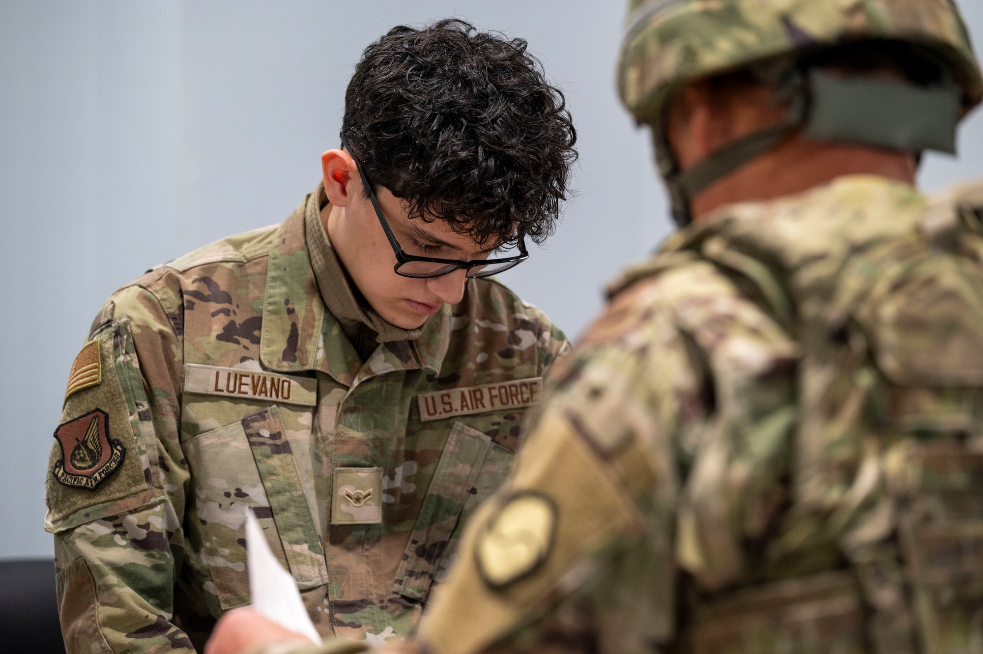 U.S. Air Force Airman Kevin Luevano, 51st Force Support Squadron personnel, processes a Korean Service Corps Pyeongtaek Mobilization Station member during a simulated contingency operations training at Osan Air Base, Republic of Korea, Dec. 5, 2024. This marks the first collaboration between the Korean Service Corps and the U.S. Air Force. This training will increase the 51st Fighter Wing’s warfighting and readiness capabilities. (U.S. Air Force photo by Senior Airman Sabrina Fuller-Judd)