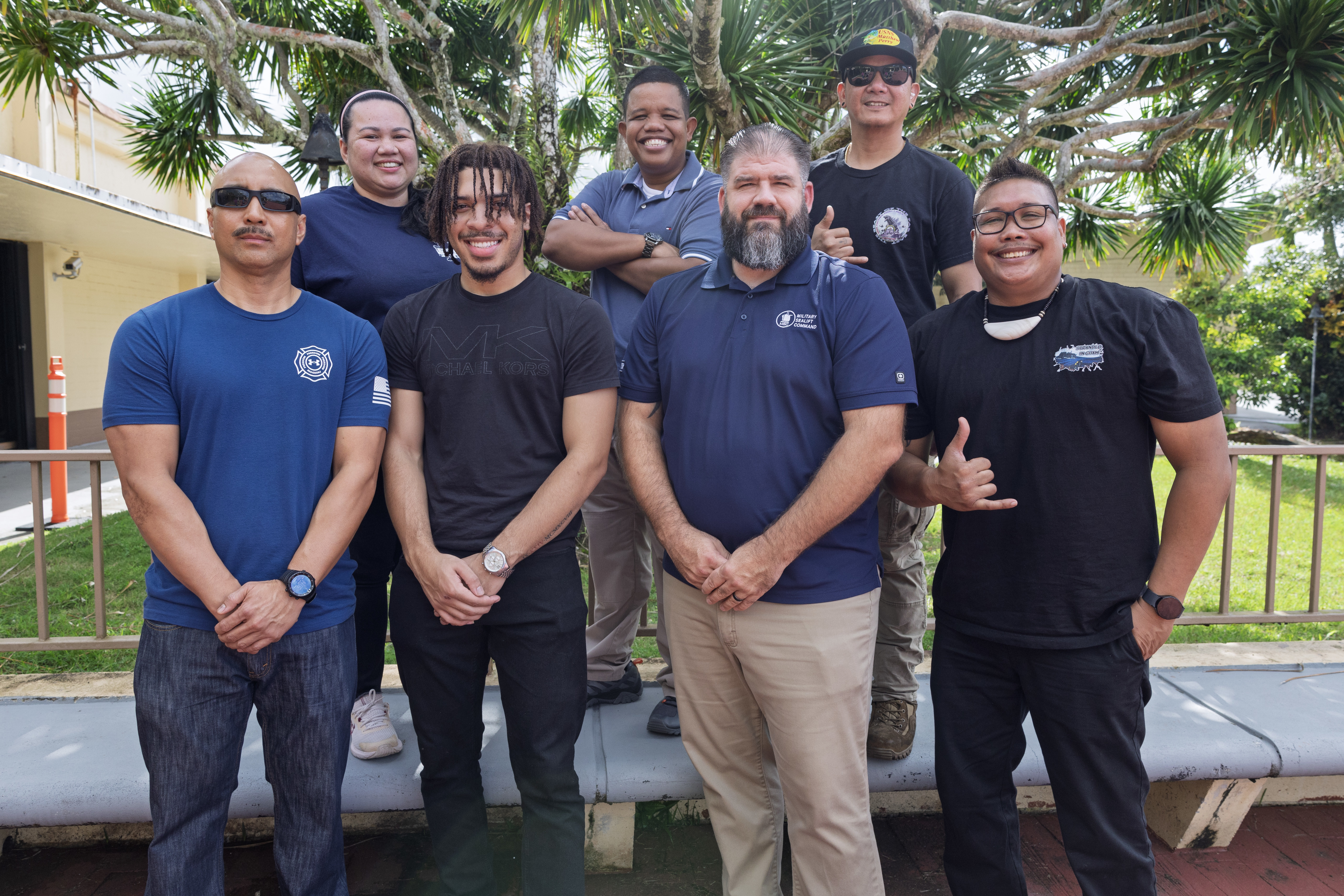 From top left, Jannet Oboza, laundryman, Military Sealift Command’s (MSC) dry cargo and ammunition ship USNS Matthew Perry (T-AKE 9); Jess Stewart, able-bodied seaman, Matthew Perry; Noel David, deck engineer machinist, Matthew Perry; second row from left, Vince A. Bersamina, yeoman, Matthew Perry; Timothy Carr, engine utilityman, Matthew Perry; Michael Mack, field recruiter, MSC; and Devin Dydasco, deck engineer machinist, Matthew Perry; pose for a group photo at a job fair in the Top o’ the Mar reception center at the Nimitz Hill Annex, in Asan, Dec. 11.