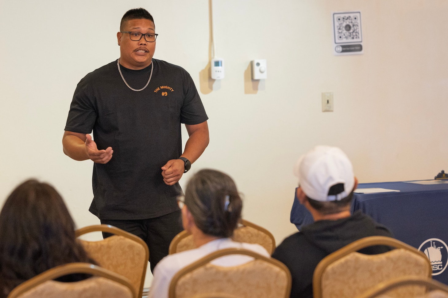 Devin Dydasco, deck engineer machinist, with Military Sealift Command’s dry cargo and ammunition ship USNS Matthew Perry (T-AKE 9), speaks to interested applicants at a job fair in the Top o’ the Mar reception center at the Nimitz Hill Annex, in Asan, Dec. 10.