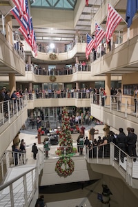 McNamara Headquarters Complex employees gathered in the building’s main lobby and around the railings during the site’s annual holiday tree lighting ceremony