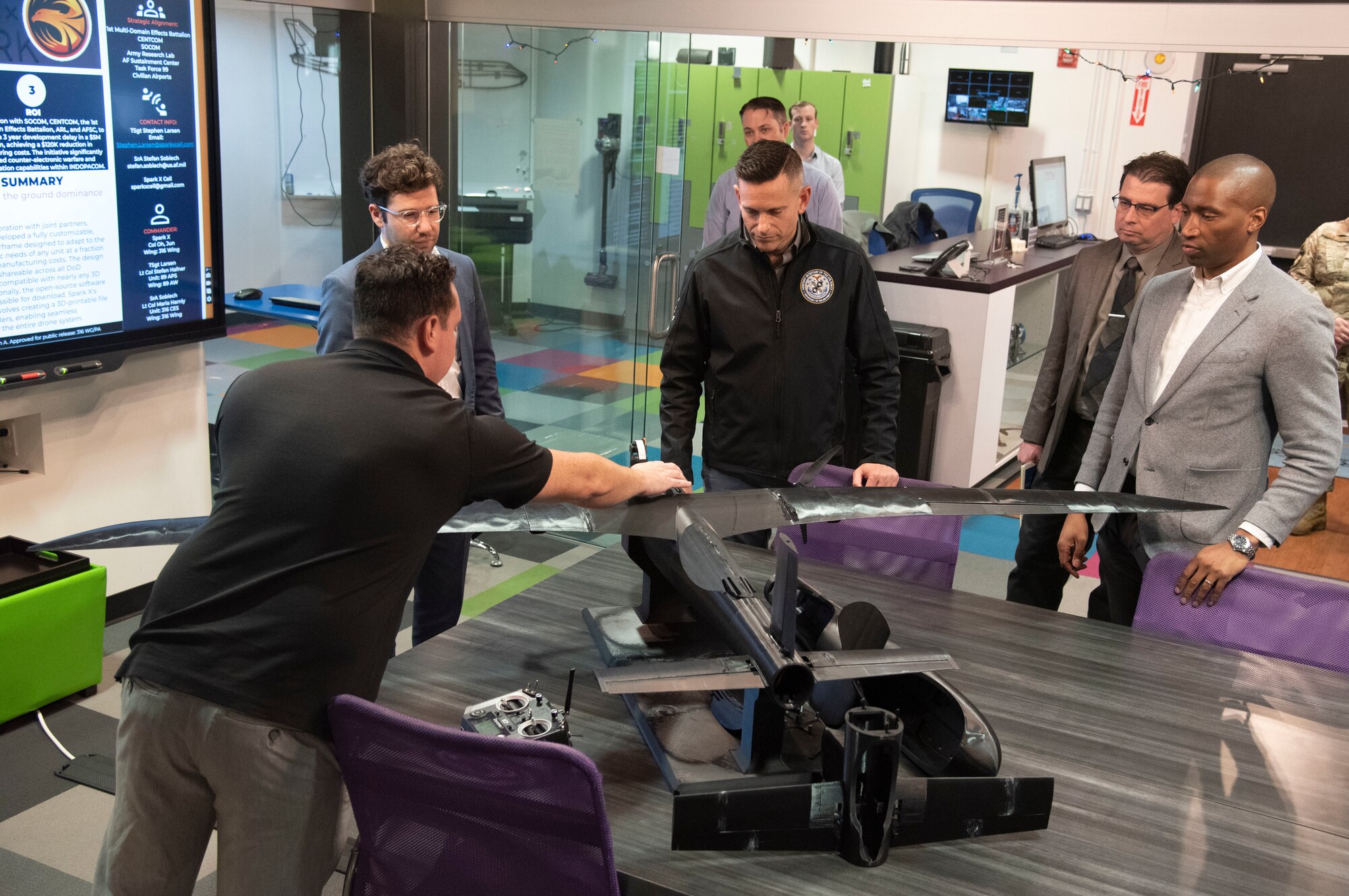 U.S. Air Force Tech. Sgt. Stephen Larsen, Spark X Cell Innovation and Idea Center noncommissioned officer in charge, demonstrates an unmanned aerial vehicle during a visit by the Assistant Secretary of the Air Force for Manpower and Reserve Affairs’ office.