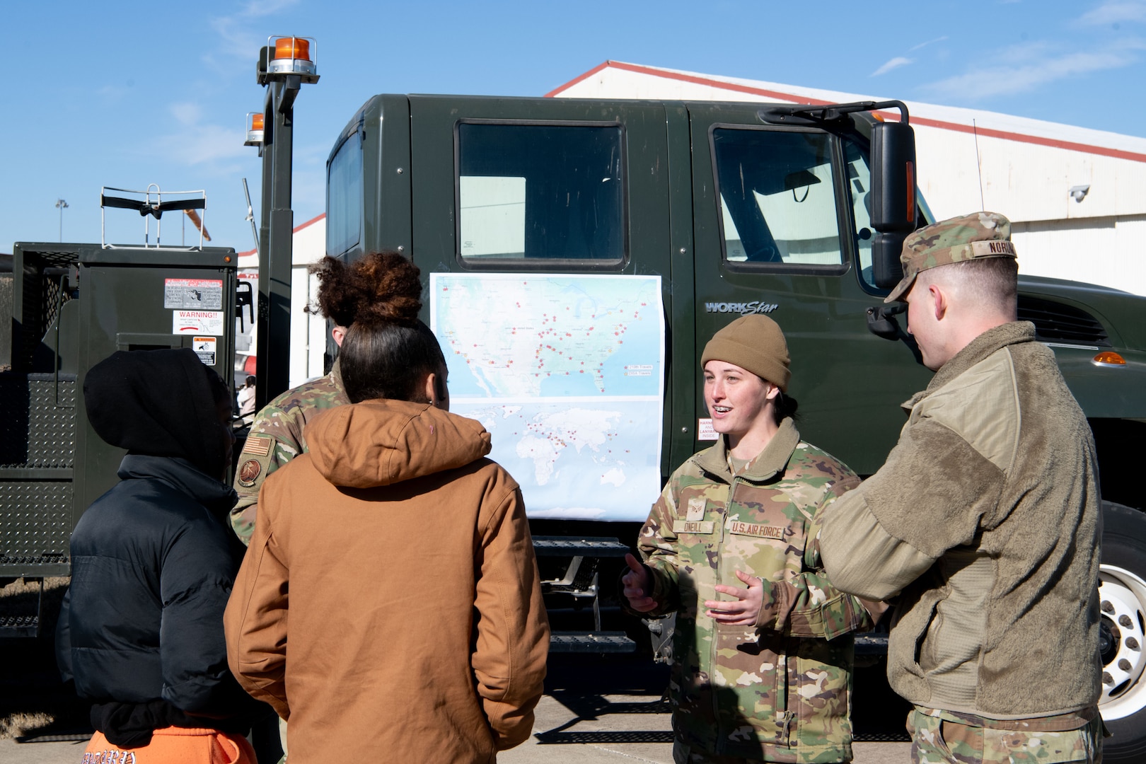 Senior Airman Brooke Oneill, 219th Engineering Installation Squadron, speaks with attendees of the eighth annual Oklahoma Women in Aviation & Aerospace Day at the Tulsa Air National Guard Base, Okla., Dec. 6, 2023. More than 1,000 students and adults in the aerospace industry came to participate in the event which included aircraft and military static displays, a panel discussion, guest speakers, and more. (Oklahoma Air National Guard photo by Master Sgt. Rebecca Imwalle)