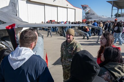 Master Sgt. Jonathan Brixey, 138th Aircraft Maintenance Squadron, speaks with attendees of the eighth annual Oklahoma Women in Aviation & Aerospace Day at the Tulsa Air National Guard Base, Okla., Dec. 6, 2023. The event was sponsored by Spartan College of Aeronautics and Technology and provided community members with an opportunity to learn from and network with individuals across the state with interests in both military and commercial aviation. (Oklahoma Air National Guard photo by Master Sgt. Rebecca Imwalle)