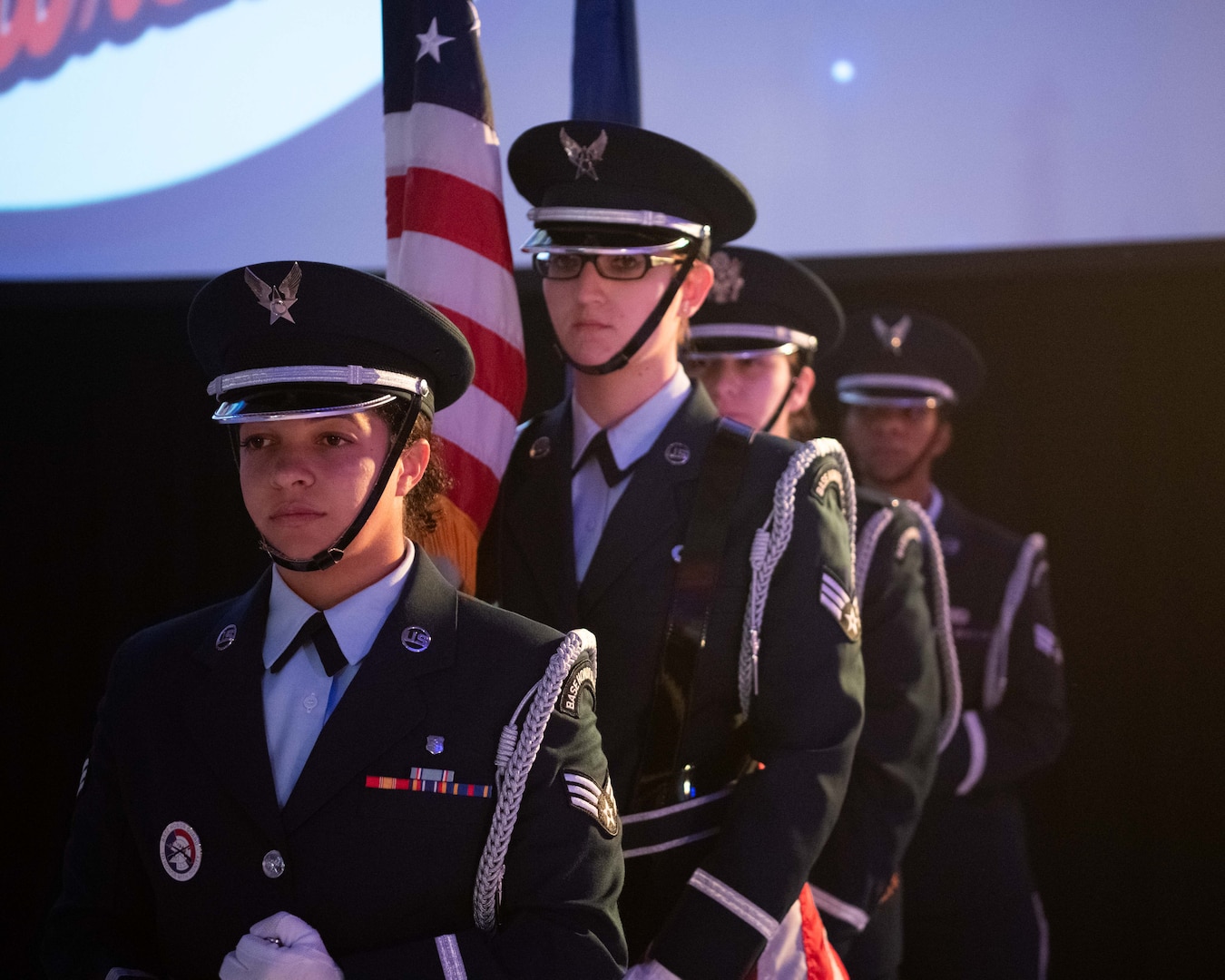 Members of the Honor Guard prepare to present the colors at the eighth annual Oklahoma Women in Aviation & Aerospace Day at the Tulsa Air National Guard Base, Okla., Dec. 6, 2023. Hudson was the emcee of the event. Throughout the day, attendees heard from several guest speakers including the 138th Fighter Wing commander, The Tinker Air Force Base commander, the Mayor of Tulsa, and more. (Oklahoma Air National Guard photo by Master Sgt. Rebecca Imwalle)