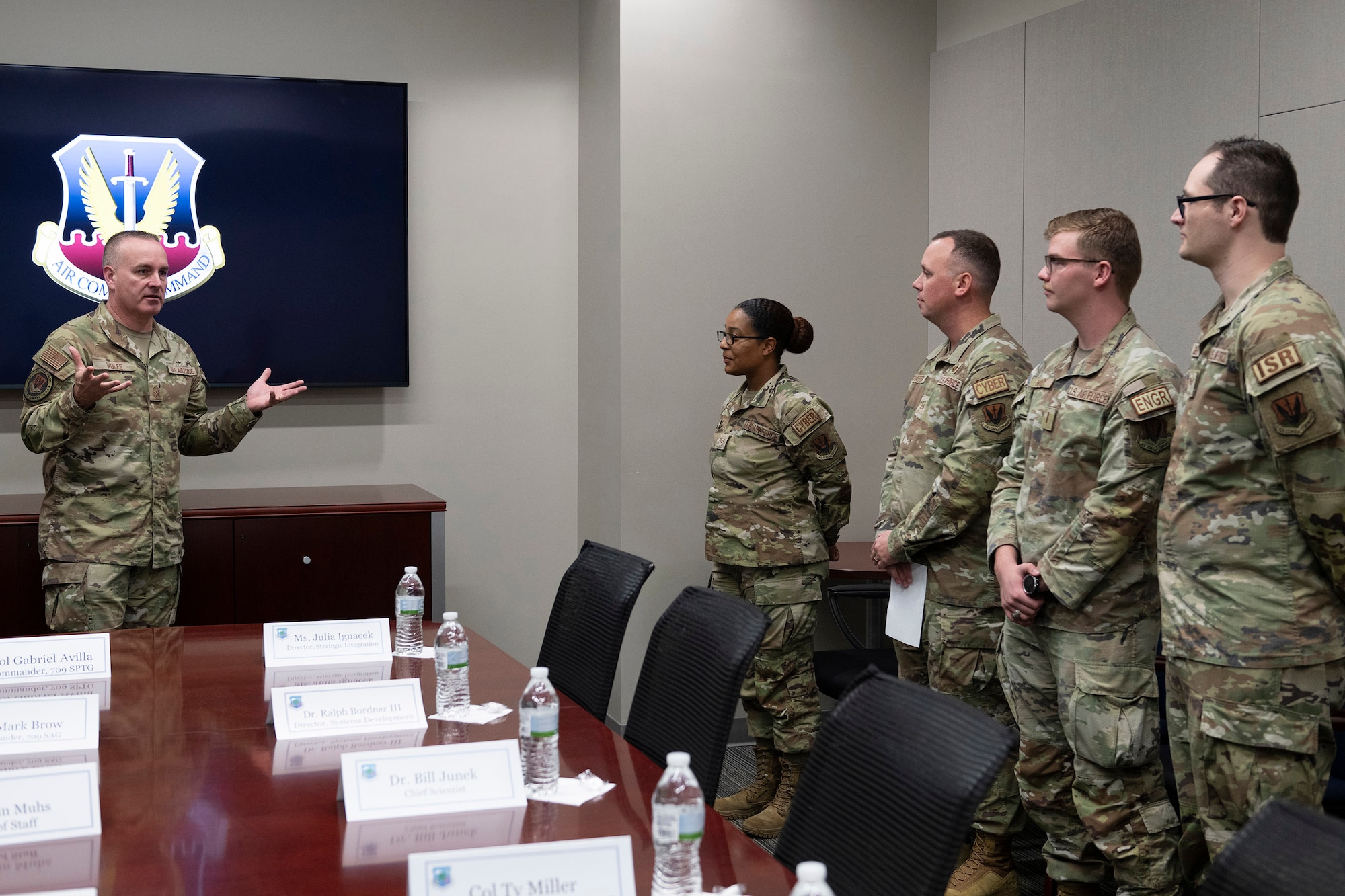 Chief Master Sgt. Dave Wolfe (left), command chief of Air Combat Command, meets with Airmen from the Air Force Technical Applications Center, Patrick Space Force Base, Fla., Dec. 5, 2024.  Wolfe accompanied Gen. Ken Wilsbach, ACC commander, on an immersion tour to learn more about the Department of Defense’s sole nuclear treaty monitoring center.  Pictured with Wolfe (from l to r):  Senior Airman Simone Williams; Master Sgt. Stephen Schaefer; 2nd Lt. Christian Moody; and Senior Airman Evan Calvert. 
  (U.S. Air Force photo by Matthew S. Jurgens)