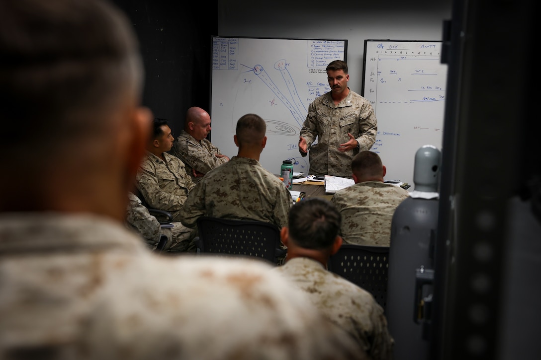 U.S. Marine Corps Capt. Michael Dugan, amphibious assault representative with Tactical Training and Exercise Control Group, Marine Air Ground Task Force Training Command, provides instruction to Marines with 2nd Battalion, 23rd Marine Regiment, 4th Marine Division, during an adversarial force exercise at Marine Air Ground Combat Center, Twentynine Palms, California, Dec. 2, 2024. Dugan’s class covered key amphibious assault strategies and urban combat tactics to enhance operational readiness and prepare the unit for its deployment to Okinawa, Japan, ensuring the Marines are fully manned, trained and equipped to meet mission challenges. (U.S. Marine Corps photo by Cpl. Madisyn Paschal)