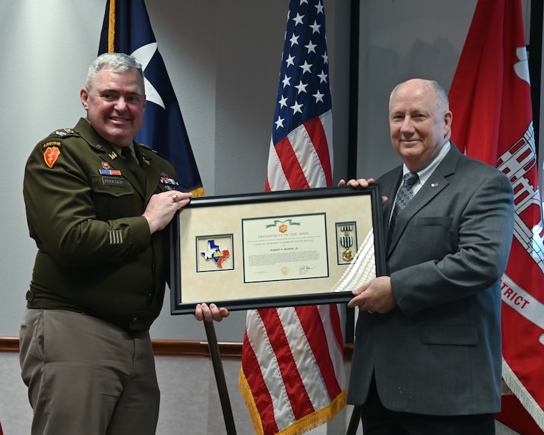 Col. Calvin Kroeger, U.S. Army Corps of Engineers' Fort Worth District commander, presents Bob Morris with the Civil Service Commendation Medal during his retirement ceremony.