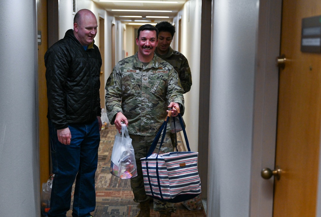 Volunteers drop off gift bags to Airmen living in base dorms