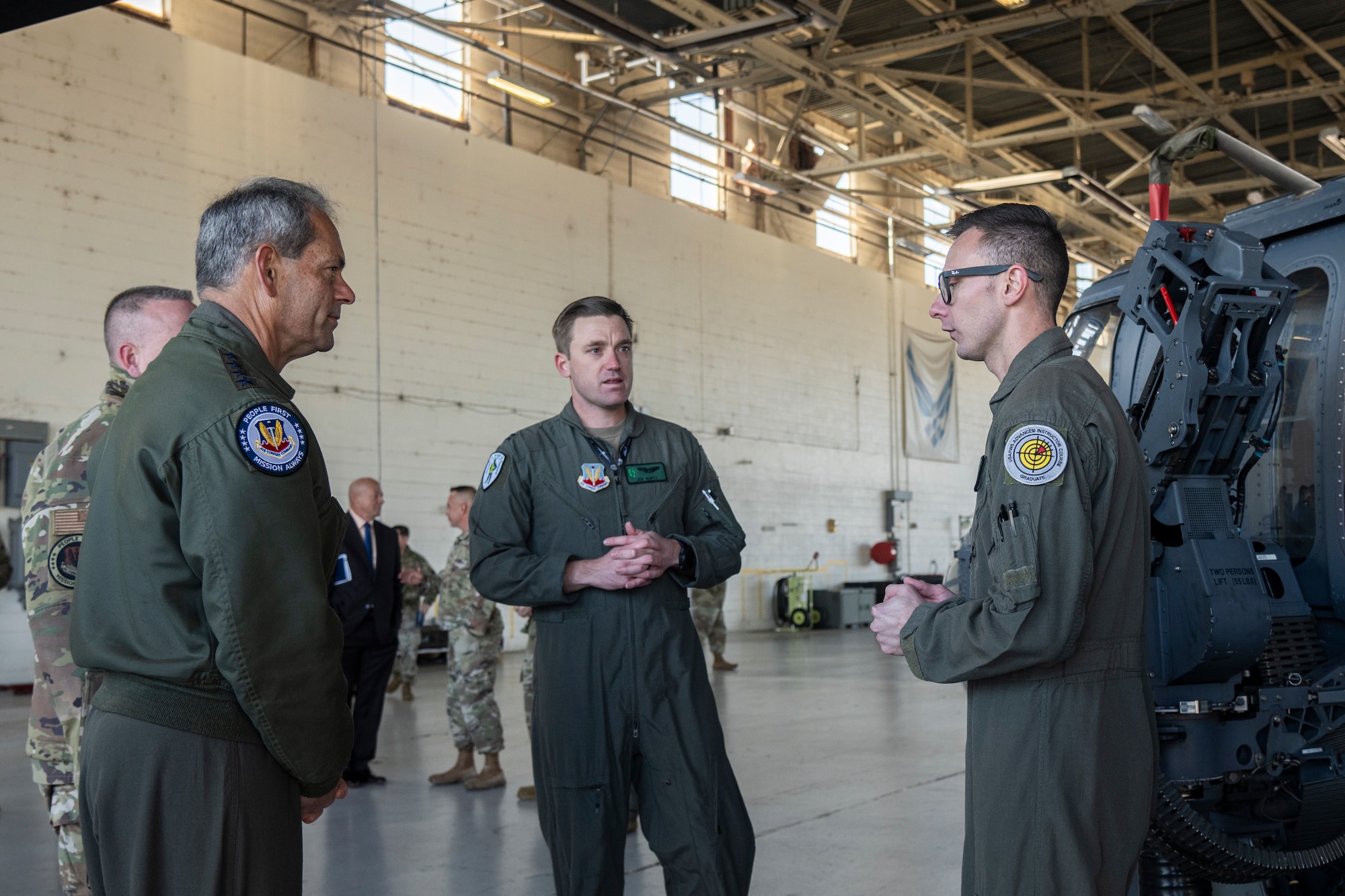 U.S. Air Force Gen. Ken Wilsbach, commander of Air Combat Command, second from left, speaks to Capt. Joe Kurtz, 41st Rescue Squadron pilot, center, and Staff Sgt. Levi McCollister,
