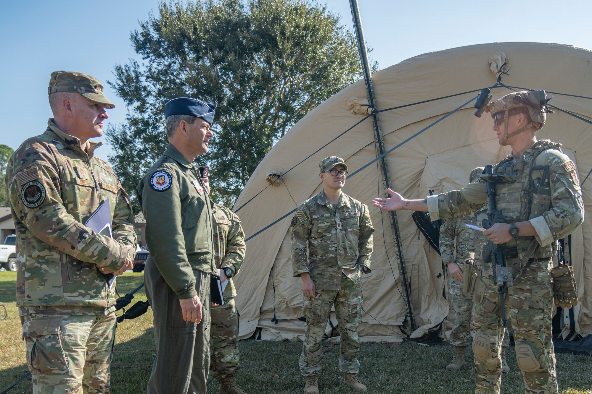 U.S. Air Force Gen. Ken Wilsbach, commander of Air Combat Command and Chief Master Sgt. Dave Wolfe, ACC command chief, speak with Capt. Mati Selazek,