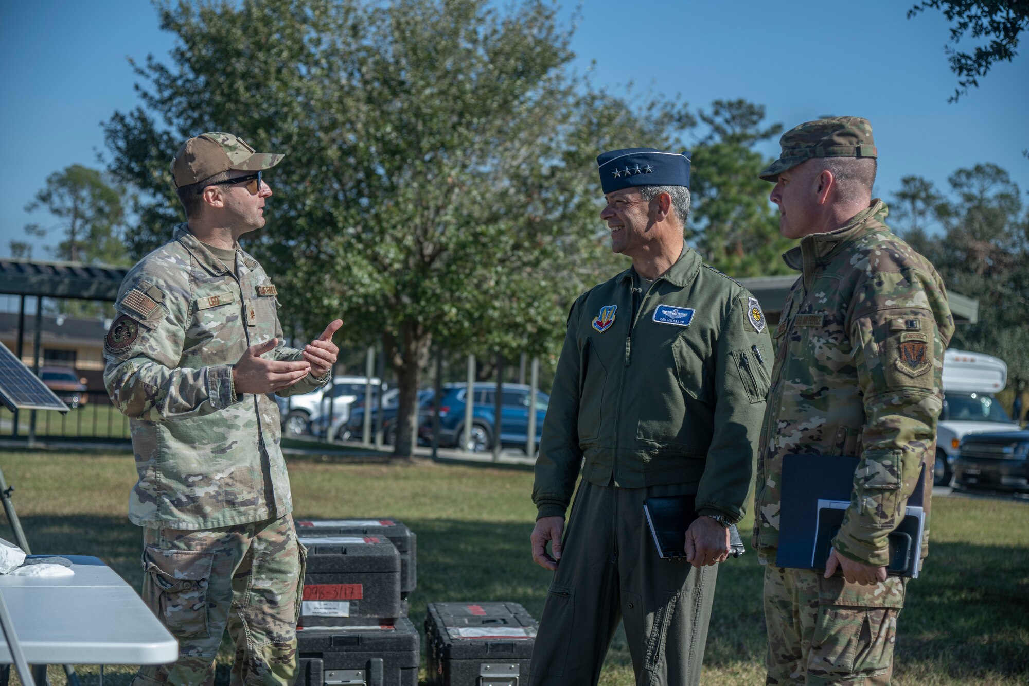U.S. Air Force Gen. Ken Wilsbach, commander of Air Combat Command, and Chief Master Sgt. Dave Wolfe, ACC command chief, speak with Maj. Justin Leo