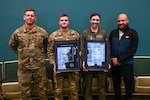 U.S. Air National Guard Master Sgt. Roman Jeter, Staff Sgt. Timothy Horton, Capt. Sinead Kirnan and Master Sgt. Jaron Brown, Airmen with the 105th Airlift Wing, pose for a photo following a Henry W. Windels Wingman Award ceremony at Stewart Air National Guard Base, Newburgh, New York, Dec. 8, 2024. Horton and Kirnan were recognized for saving the lives of Jeter and Brown.