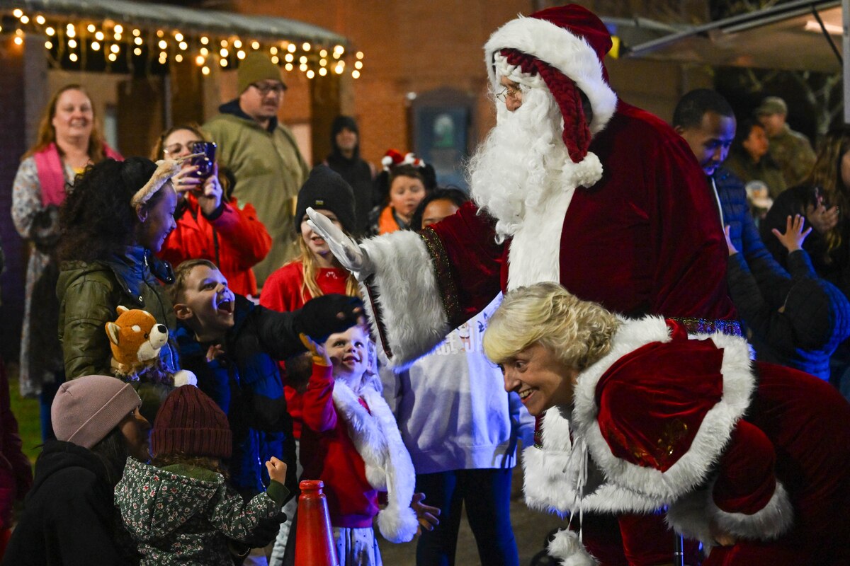 Santa Claus and Mrs. Claus greet children during the annual holiday tree lighting ceremony at RAF Lakenheath.