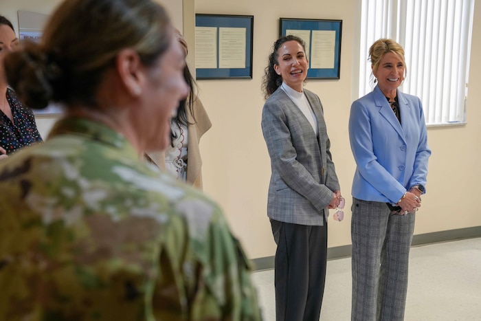 Cindy Wilsbach, wife of U.S. Air Force Gen. Ken Wilsbach, commander of Air Combat Command and Dr. Doniel Wolfe, wife of Chief Master Sgt. Dave Wolfe, ACC command chief, share a lighthearted moment with 78th Medical Group personnel