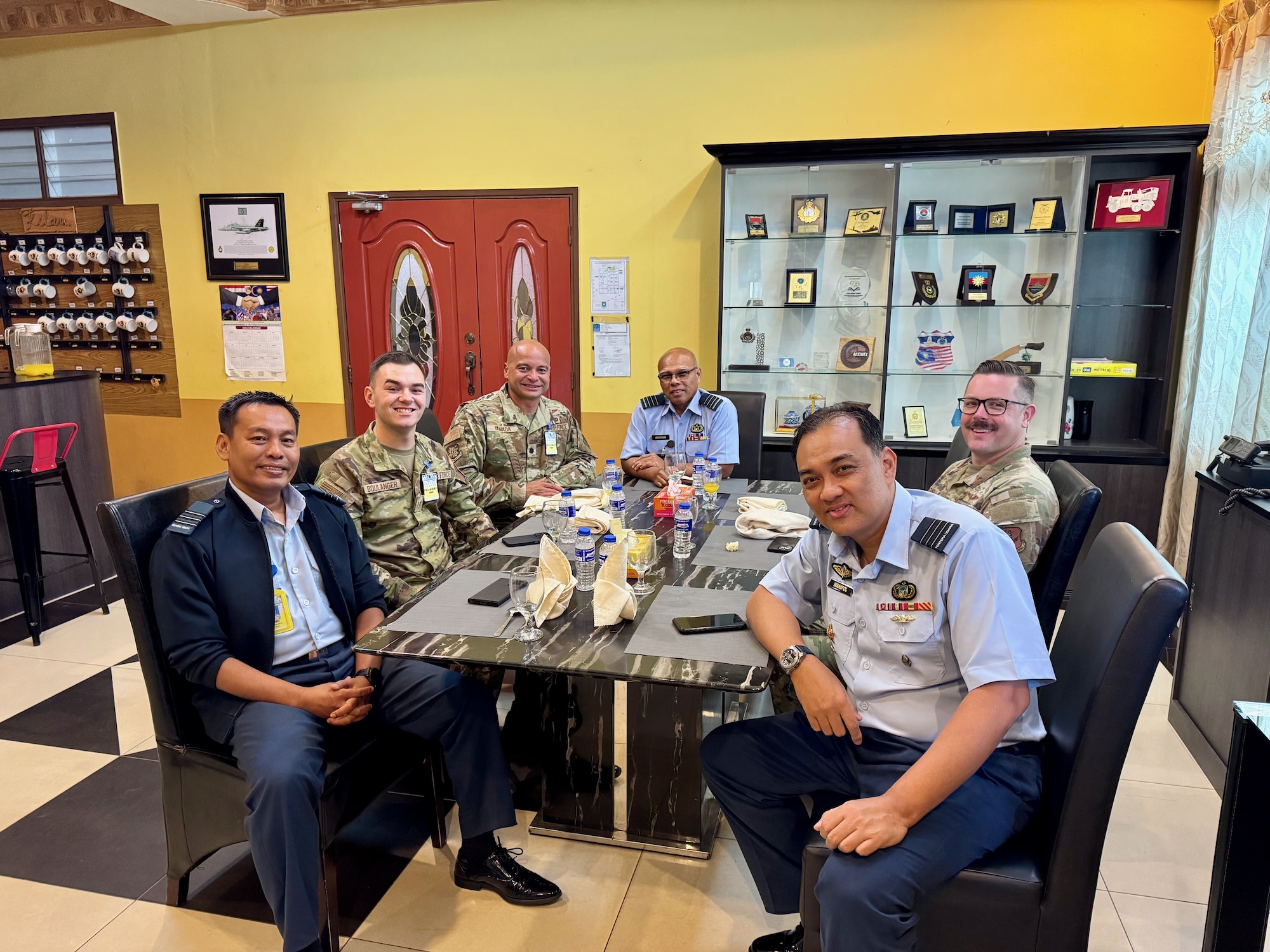 Airmen gathering around a break room table