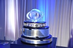 2021 Secretary of Defense Award for Sustainment Training, Advice, and Assistance of Foreign Military Forces sits on a table.